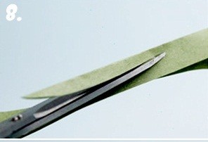 Bước 8.Gấp giấy màu xanh thành dải dài sau đó dùng kéo cắt thành hình chiếc lá hình lá tre.