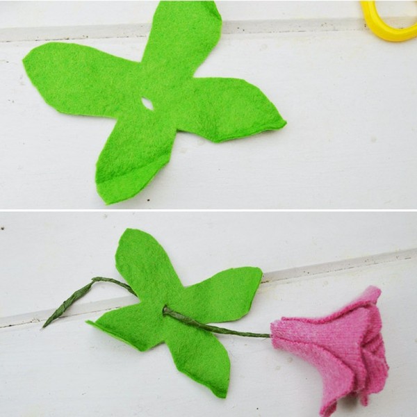 Bước 7.  Bạn dùng kéo cắt thành hình hoa 4 cánh, bạn cắt thêm 1 lỗ nhỏ ở giữa sau đó bạn lồng vào phía dưới của bông hoa tạo thành đài của bông hoa hồng.
 