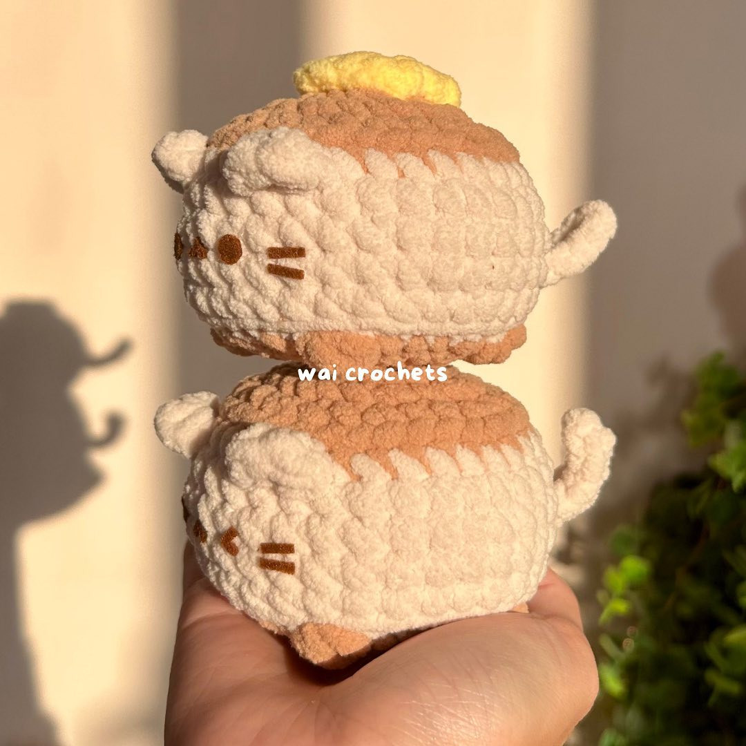 Fat cat crochet pattern with butter on her head.