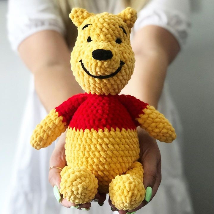 Yellow bear crochet pattern wearing a red shirt with a black nose