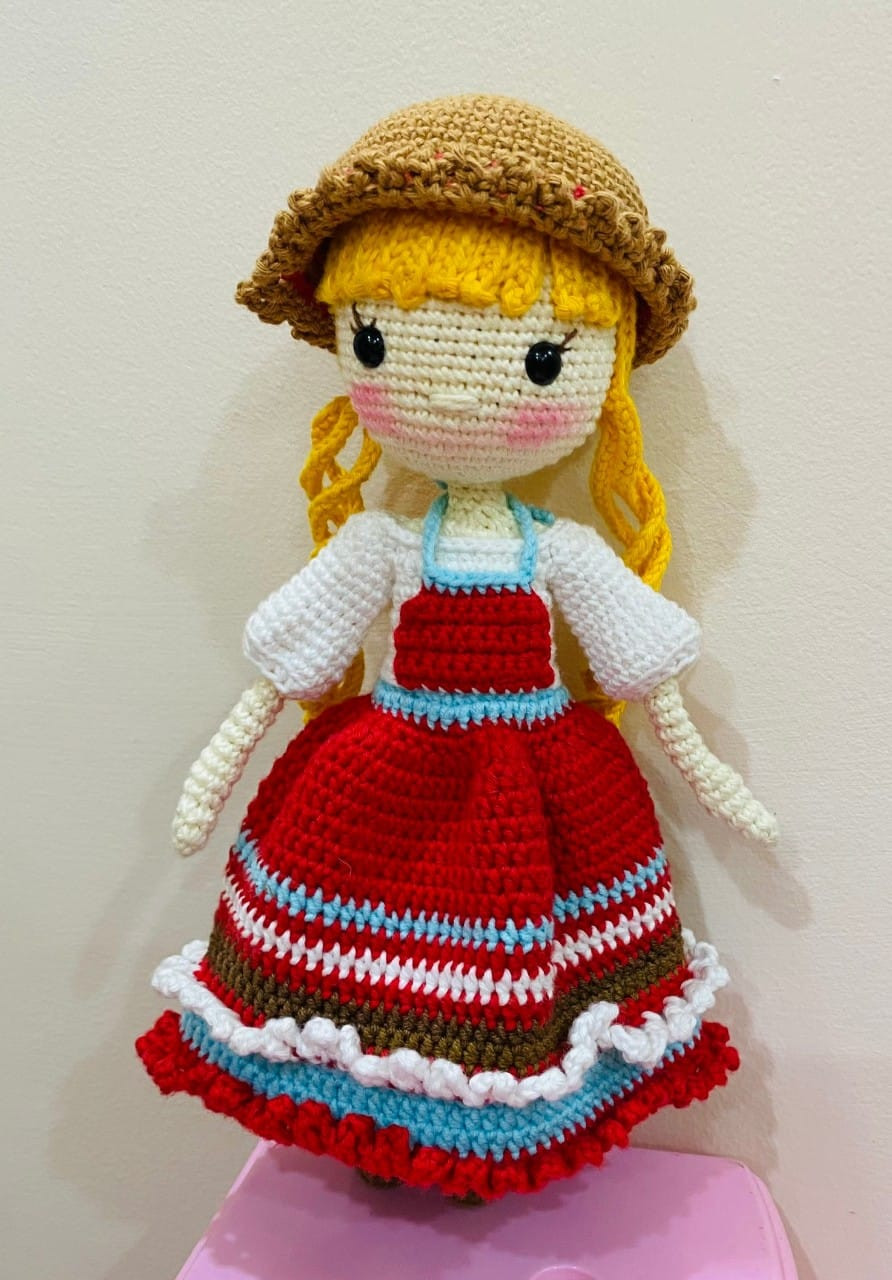 blonde doll wearing hat wearing red dress.crochet pattern