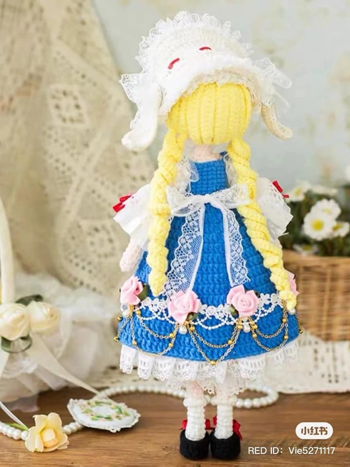 crochet pattern blonde doll wearing blue dress.