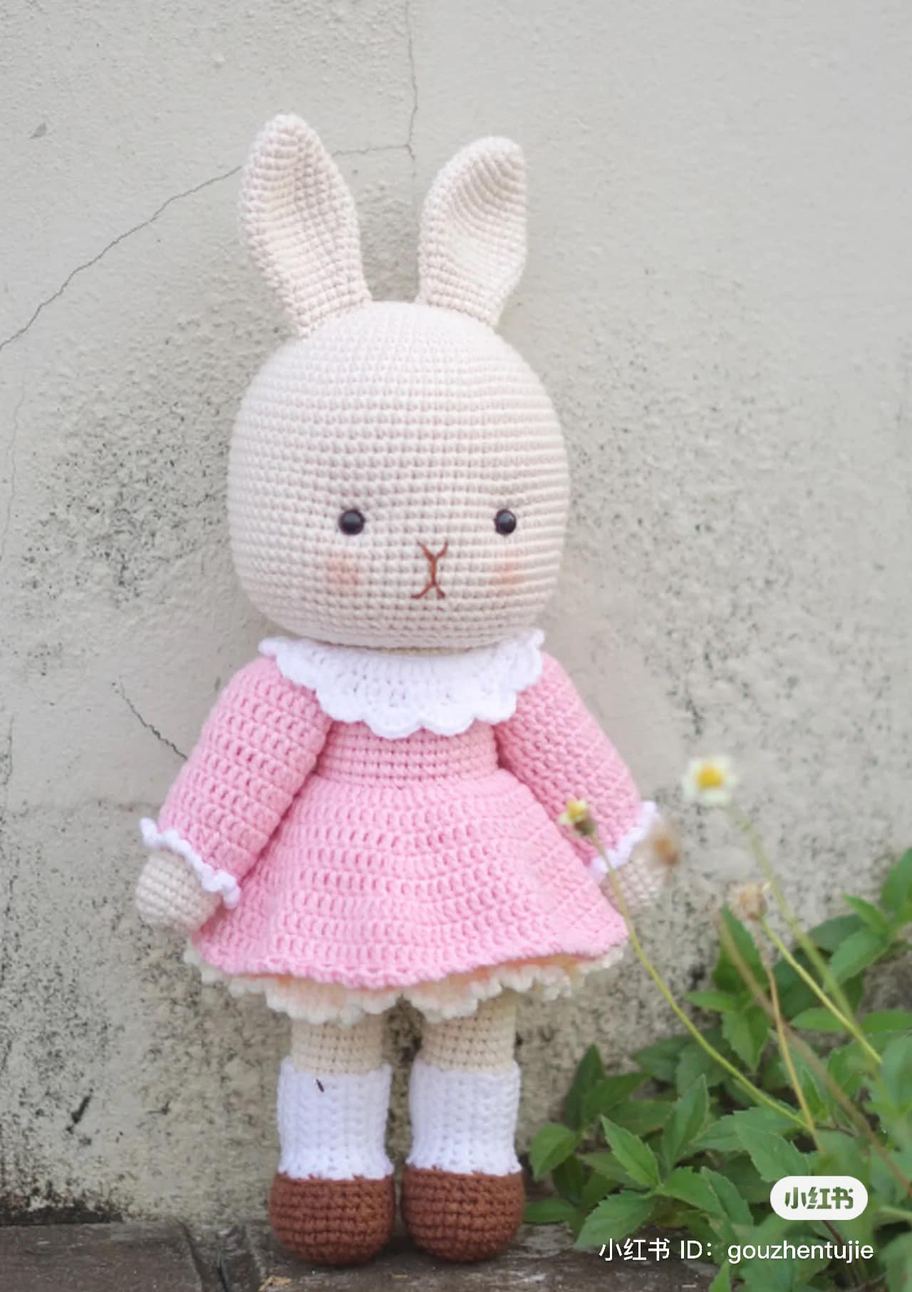 crochet pattern white rabbit long ears wearing pink dress.