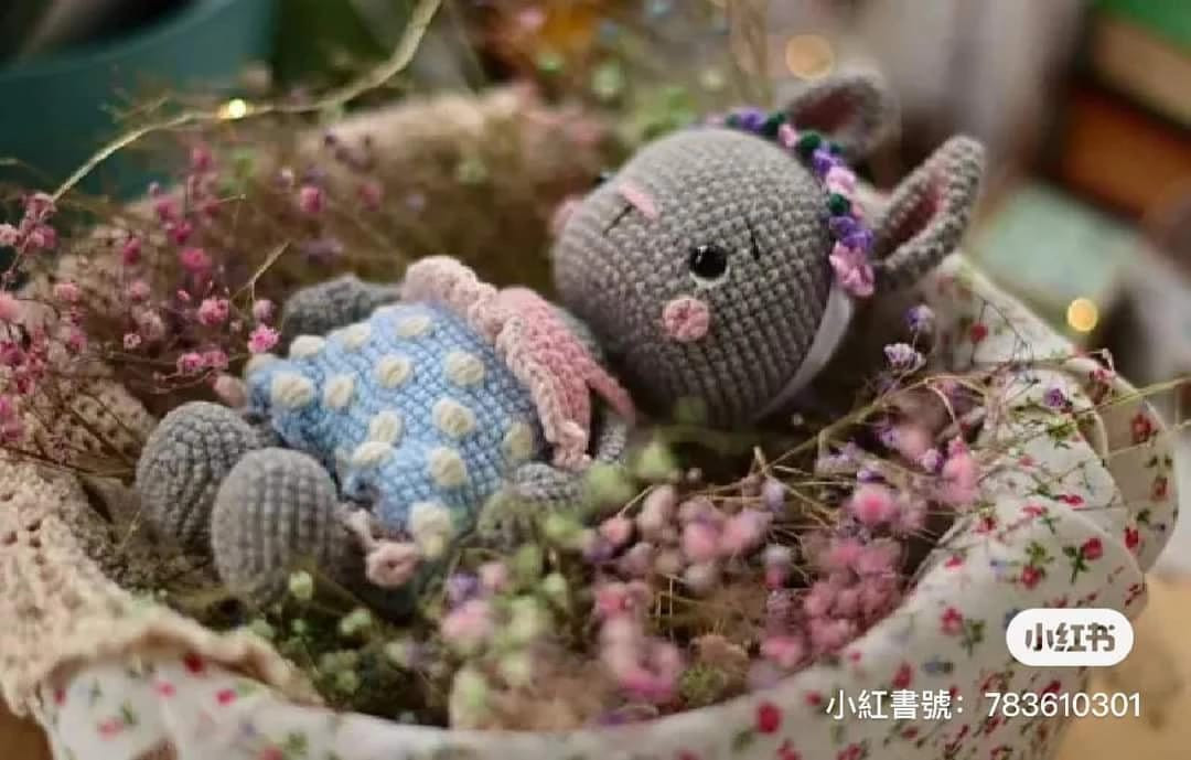gray rabbit wearing pink crochet pattern dress