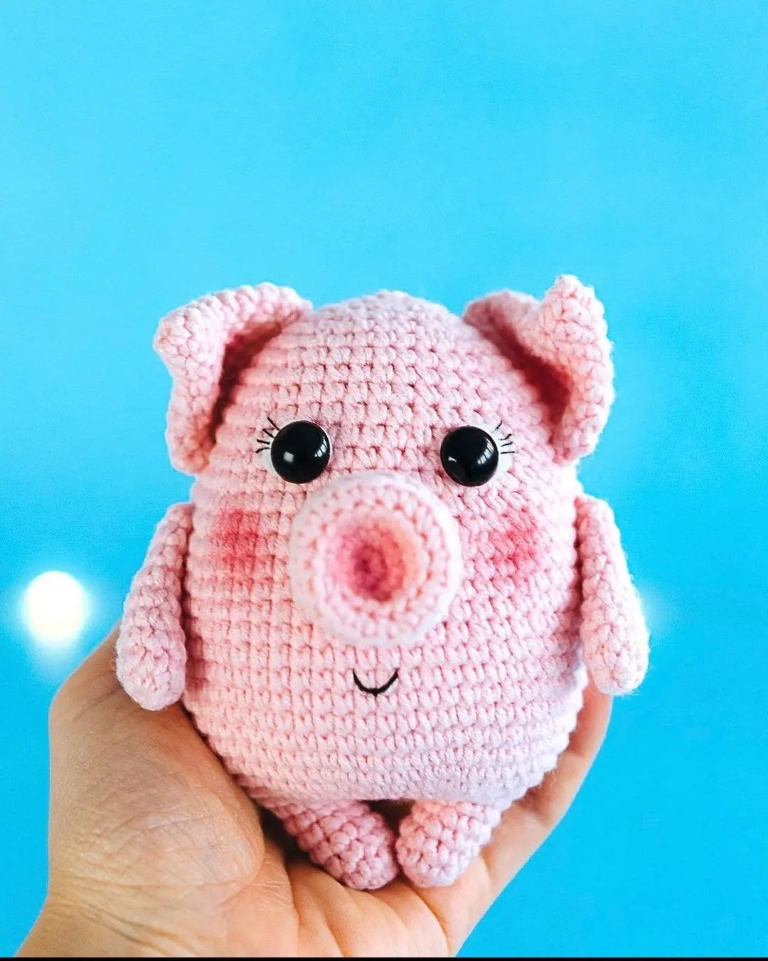 Pink pig crochet pattern wearing a blue hat.