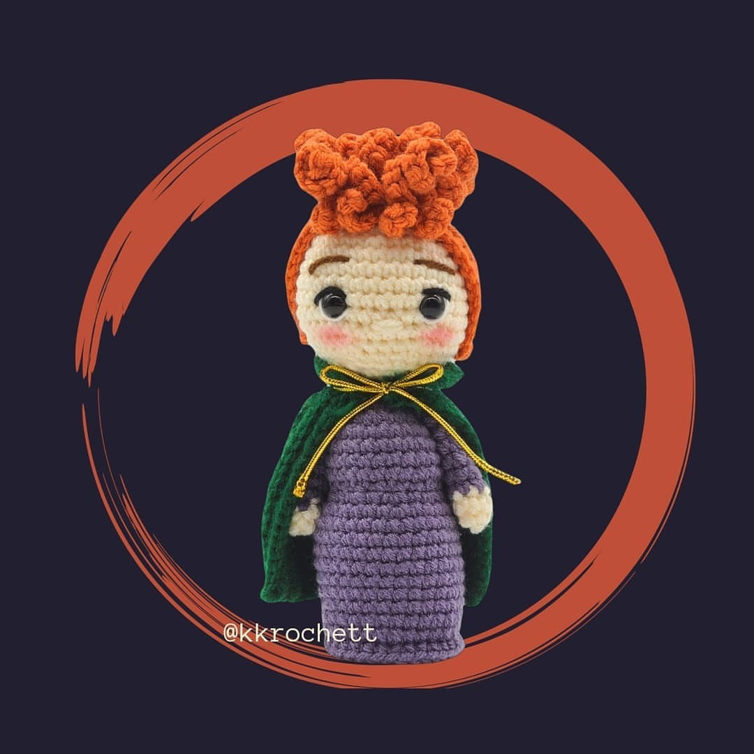 Red-haired doll wearing a blue robe.