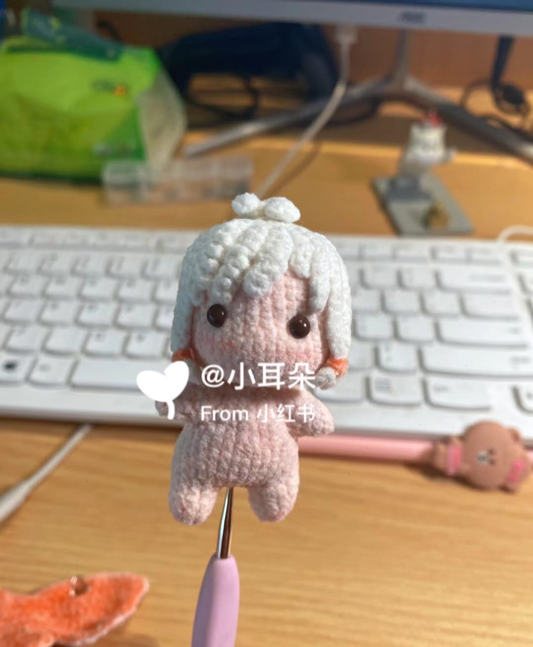 white hair doll wearing pink crochet pattern