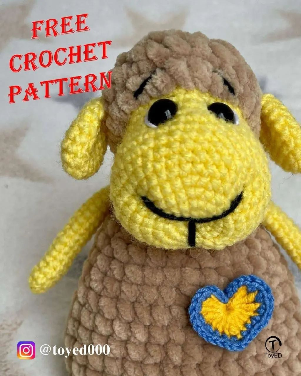 Yellow sheep's wool crochet pattern, gray fur, wearing a heart.