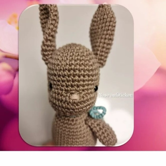 free crochet pattern brown rabbit tied with a bow at the neck.