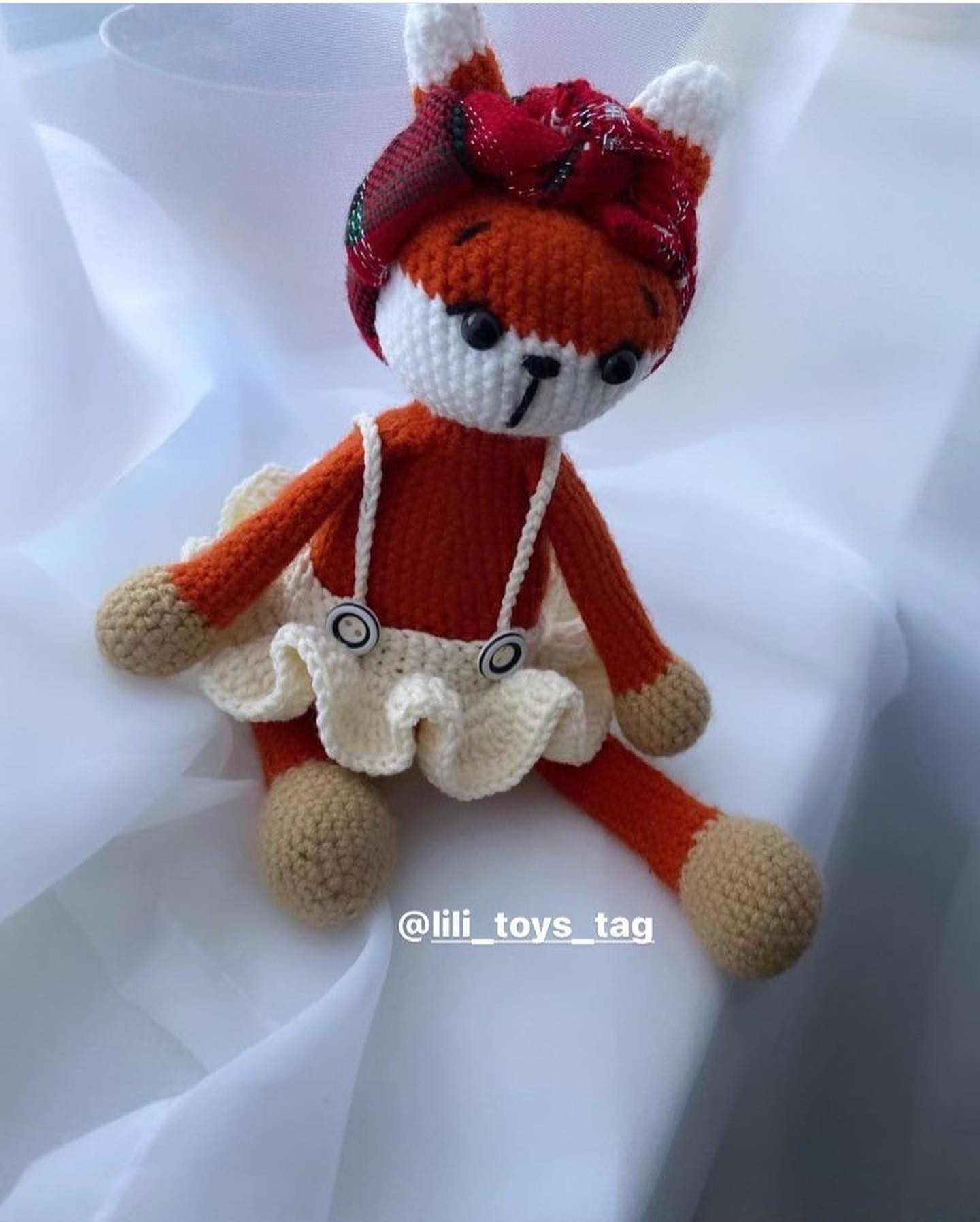 red fox wearing white crochet pattern dress