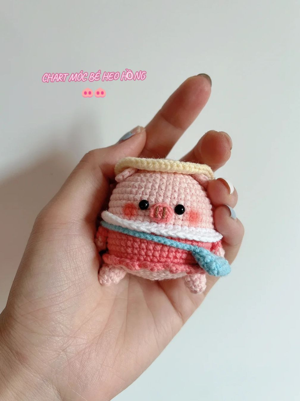 Crochet pattern for a pink pig wearing a hat and a crossbody bag