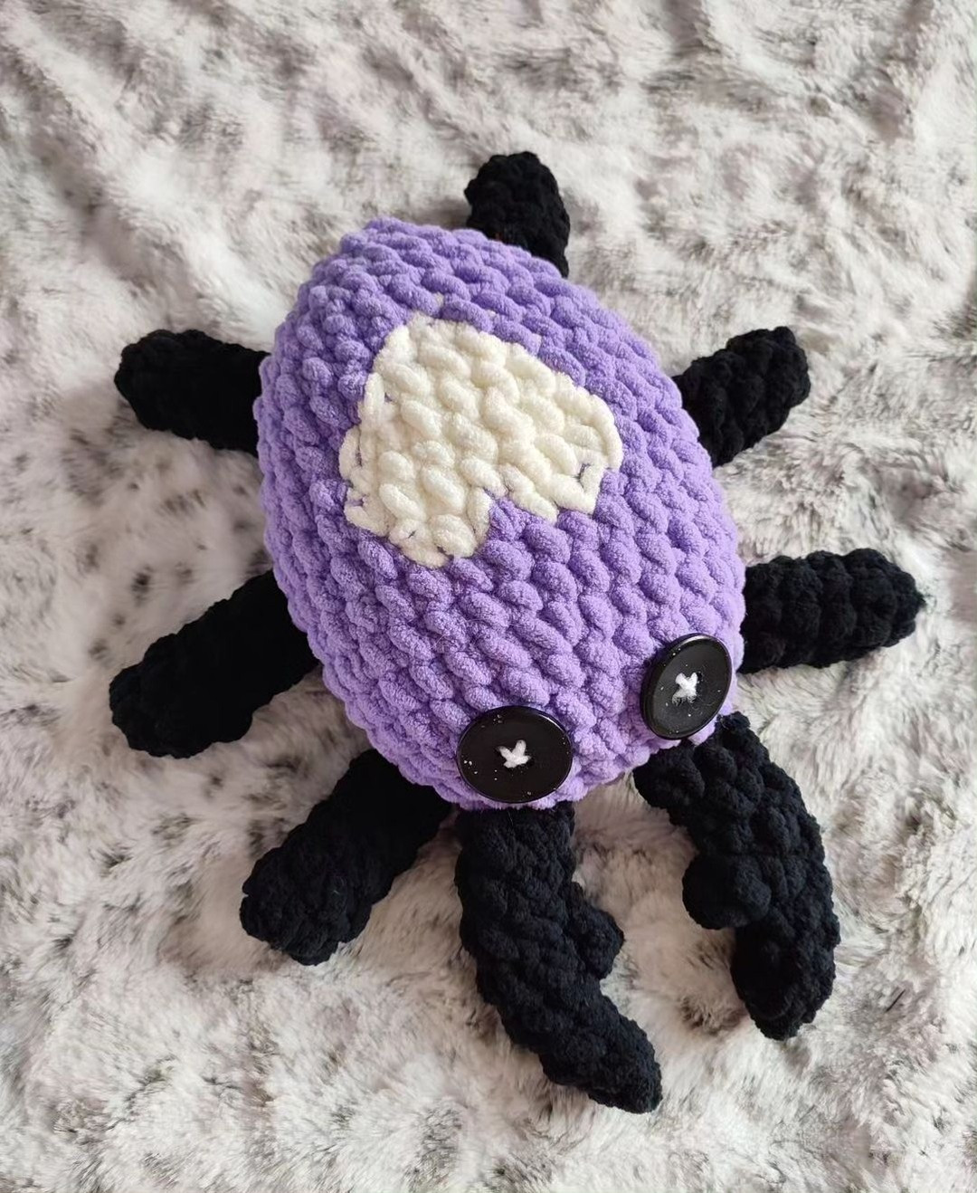 purple spider with a white heart crochet pattern