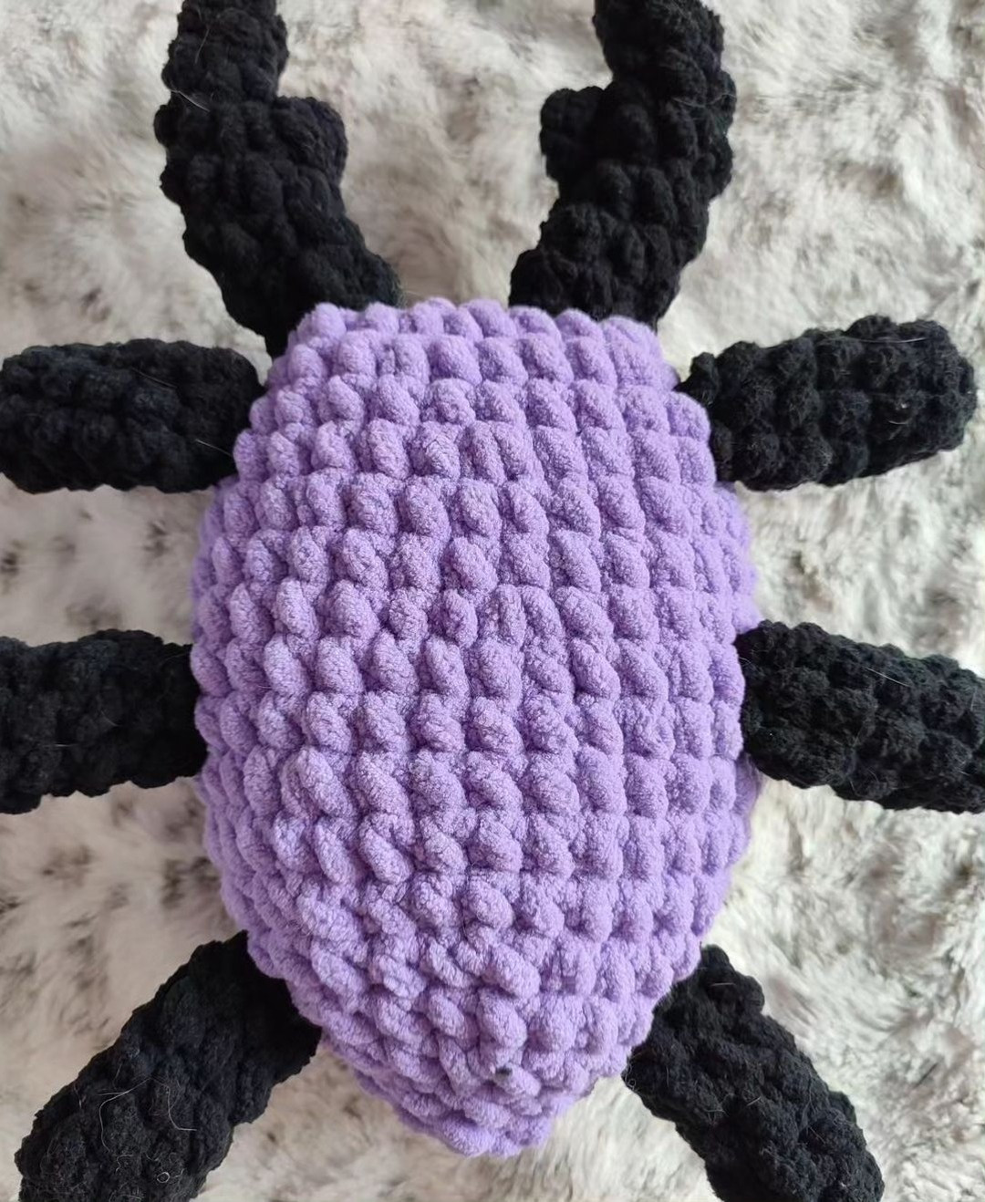 purple spider with a white heart crochet pattern