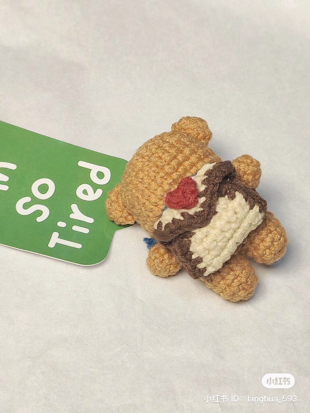 Crochet pattern for a brown bear wearing a green scarf and carrying a school bag