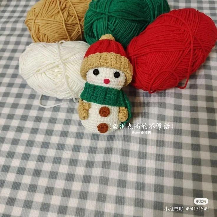 Crochet pattern for a snowman wearing a hat and scarf