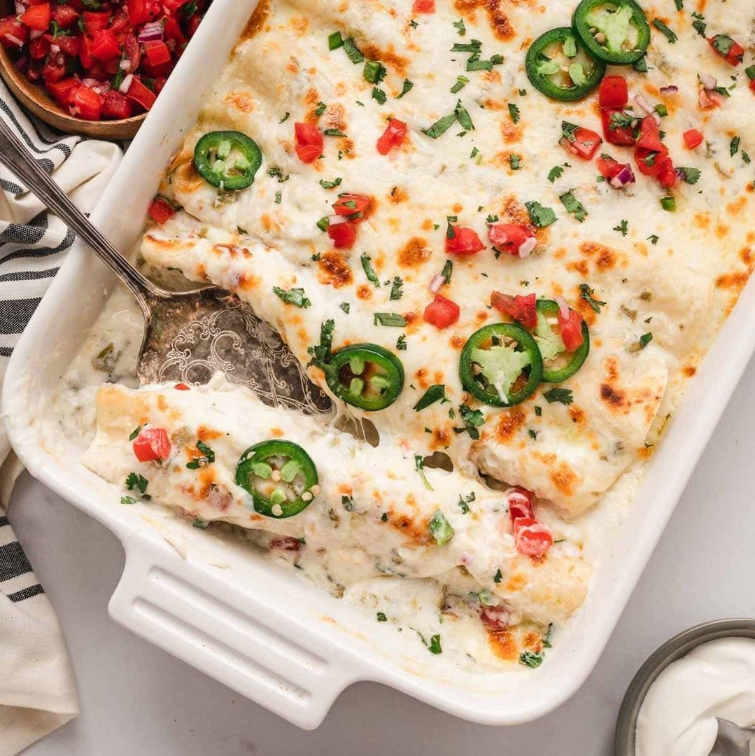 A comforting twist on traditional enchiladas, White Chicken Enchiladas are topped with a creamy sour cream-based green chile sauce. It's a family favorite and it's ready in 40 minutes!⁠