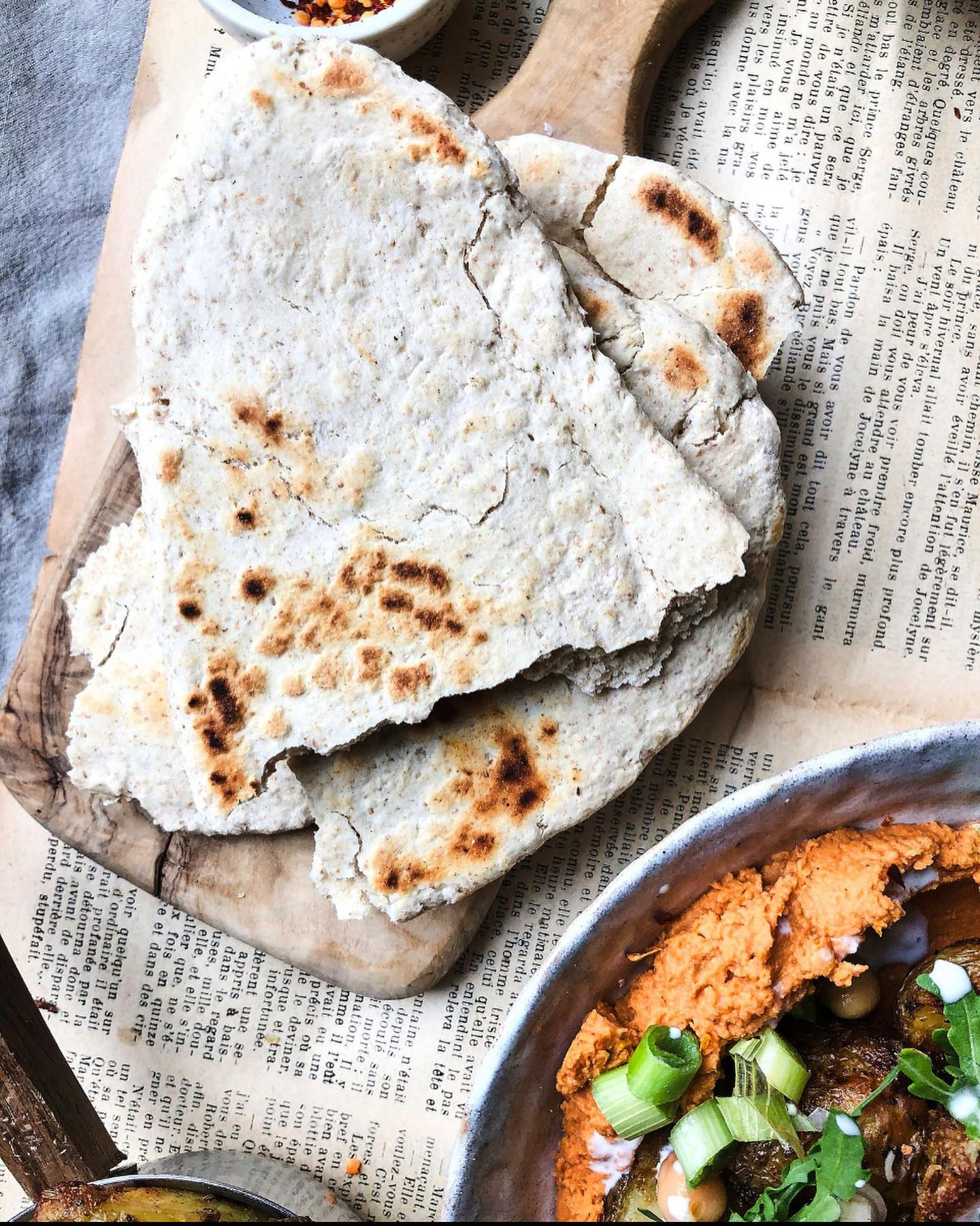 Crispy potatoes with harissa hummus and flatbread - a simple but delicious meal