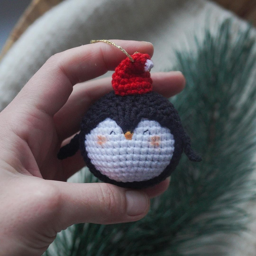 Crochet pattern for a penguin keychain wearing a Christmas hat