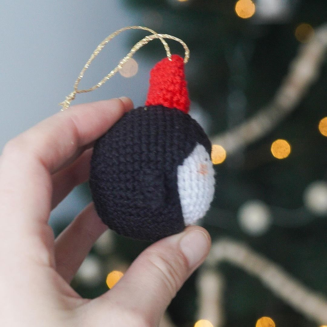 Crochet pattern for a penguin keychain wearing a Christmas hat