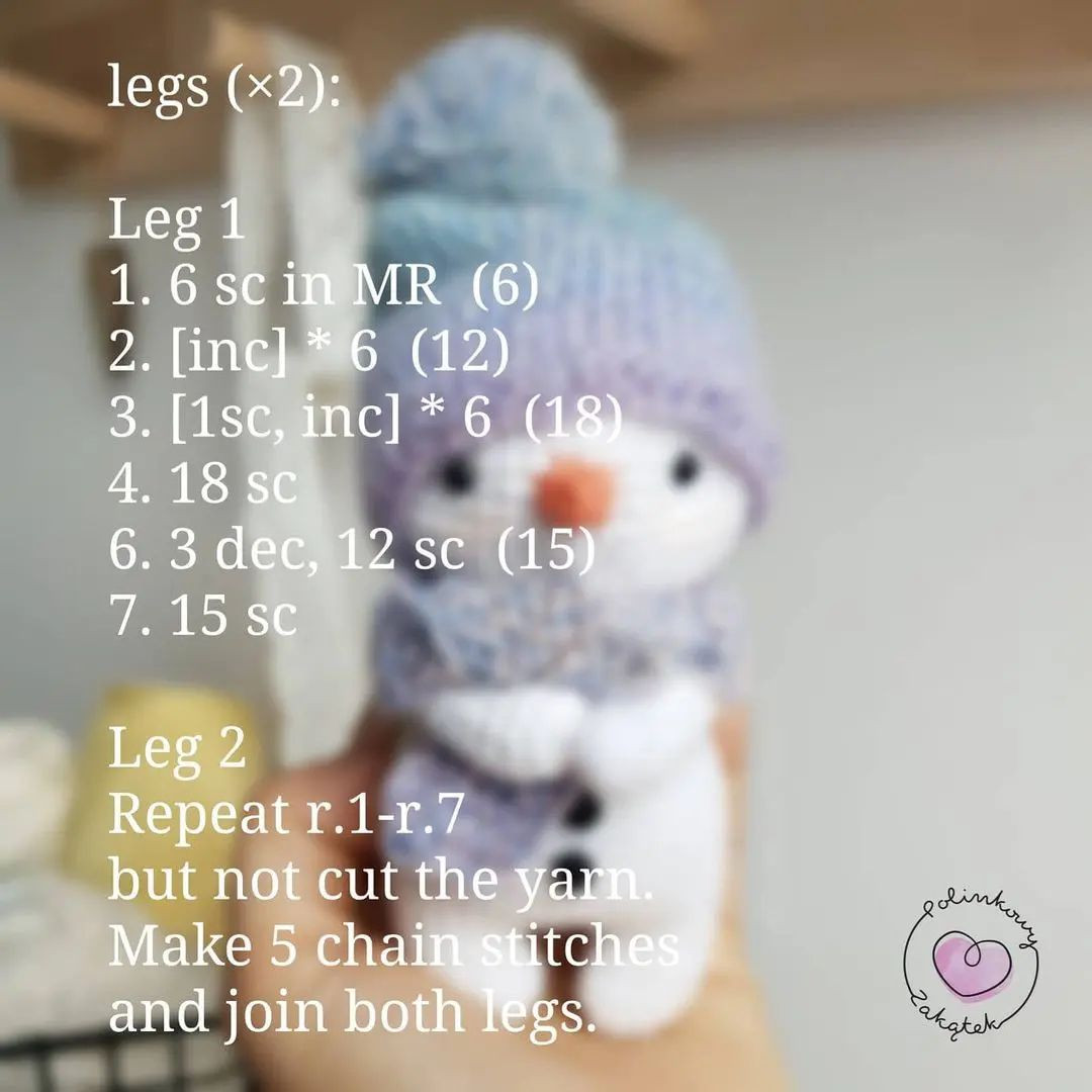 Crochet pattern for a snowman wearing an orange hat and scarf