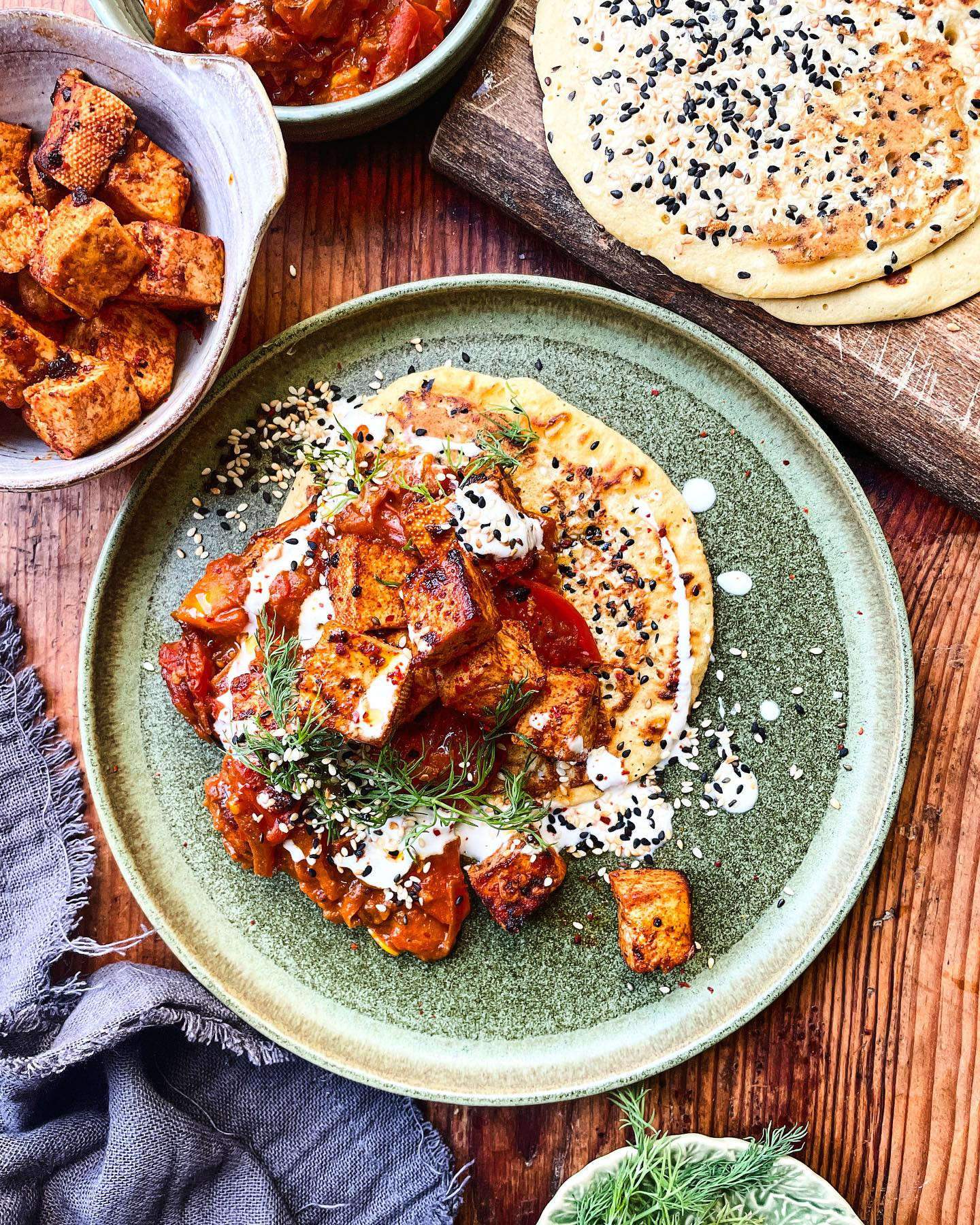 One of my favourite layered dishes for you - Harissa tomatoes, crispy soy tofu, gram flour flatbread, yogurt and salty seeds!