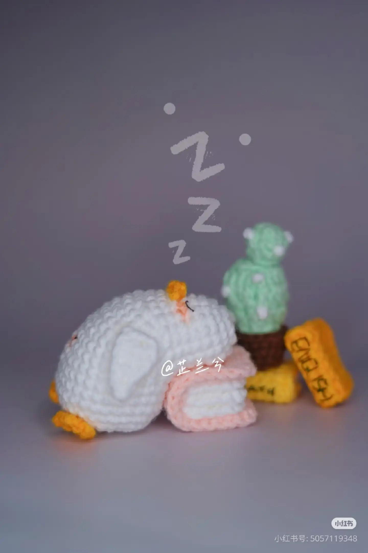 Crochet Penguin Sleeping on Books with Cactus