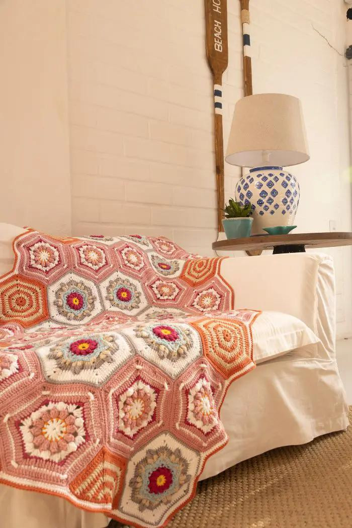 Manta de crochê hexagonal colorida com padrão de flores vibrantes