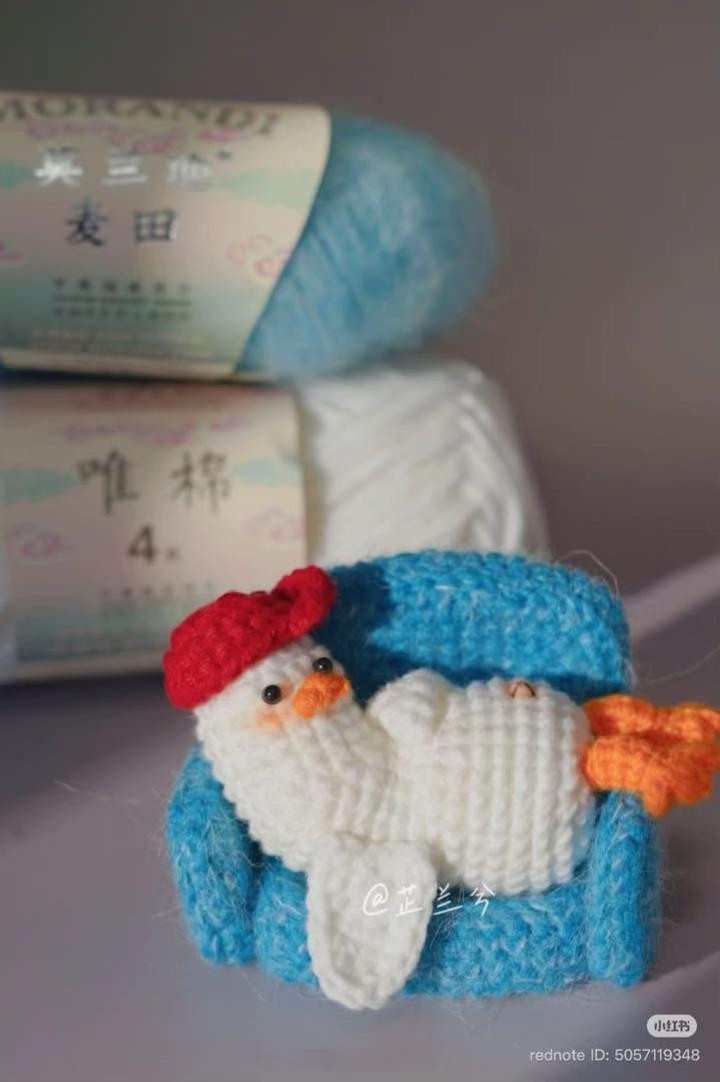 Crochet Duck Relaxing on a Cozy Blue Couch