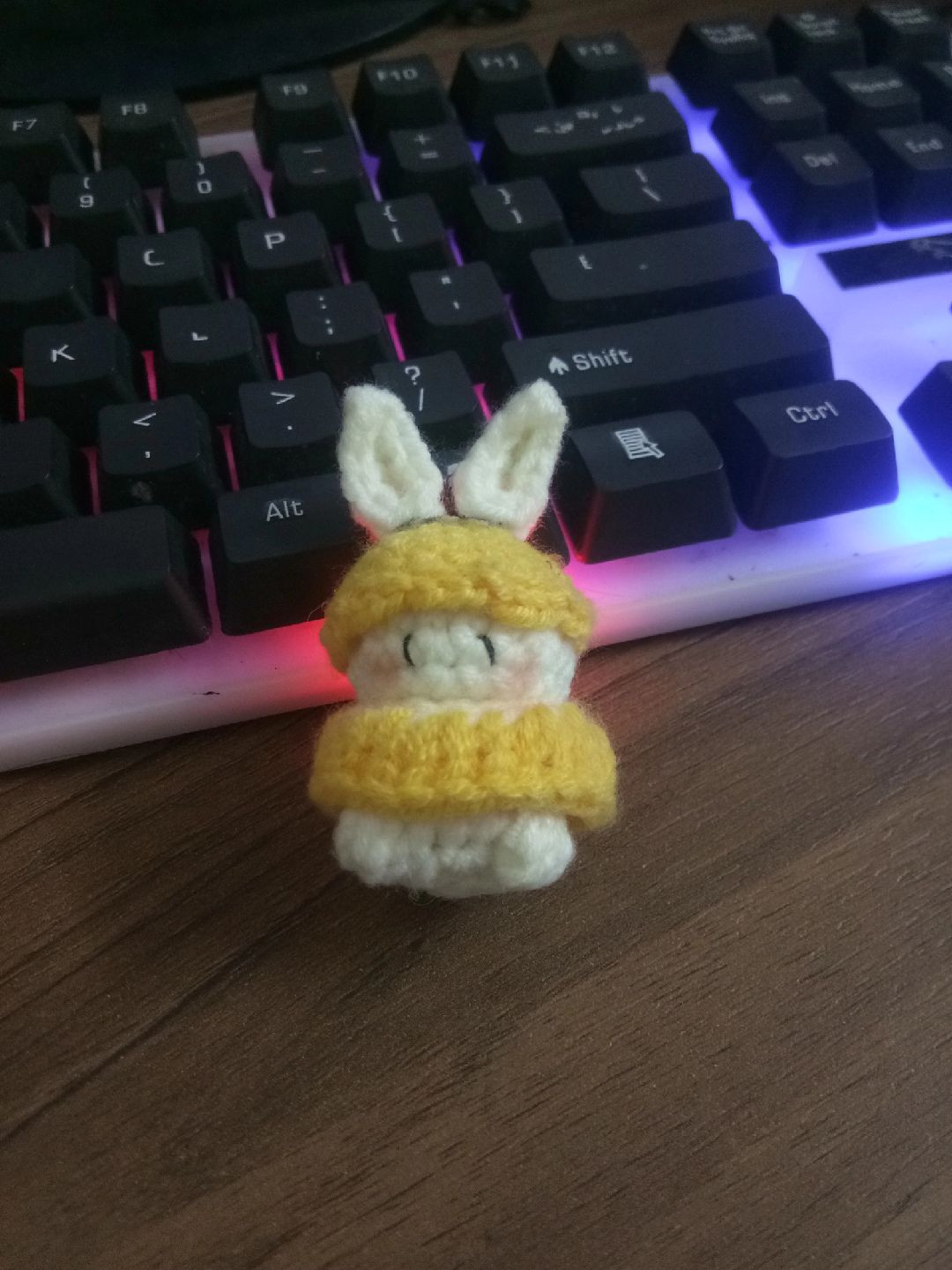 Cute Crochet Bunny in Yellow Outfit on Keyboard