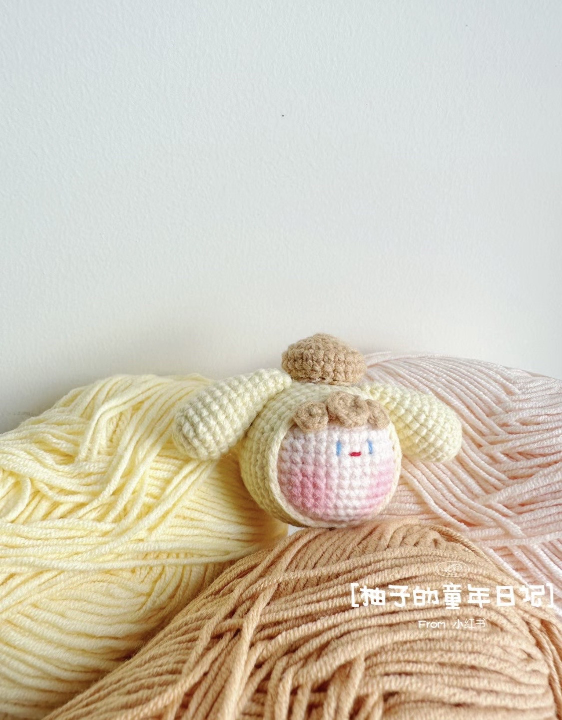 Cute Crochet Bunny Toy Surrounded by Colorful Yarn Balls