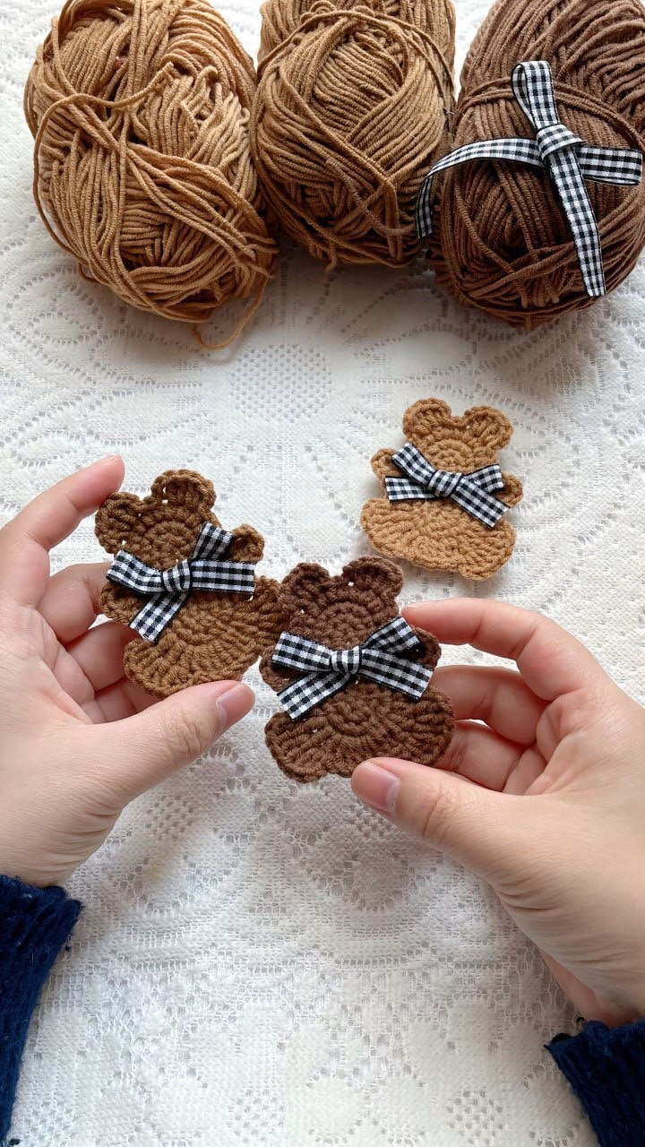 Crochet Teddy Bear Pattern with Checkered Bows and Brown Yarn
