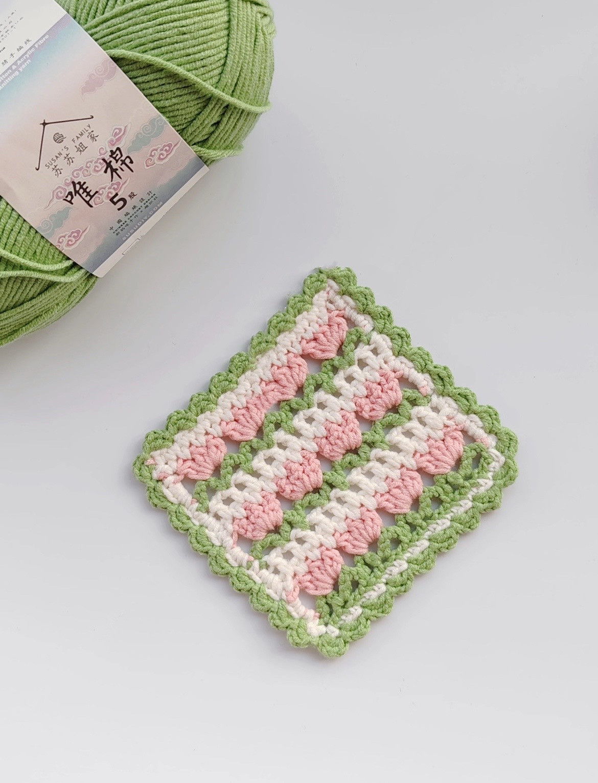 Colorful Crochet Square with Green, Pink, and White Stripes