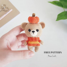 A bear crochet pattern wearing a pumpkin hat