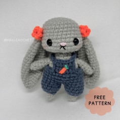 Gray rabbit crochet pattern with red bow and overalls