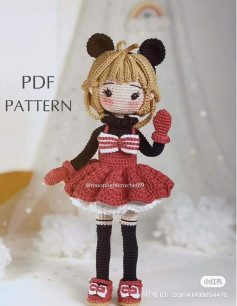 Pattern crochet doll with blonde hair, wearing a black mane, wearing a red dress.