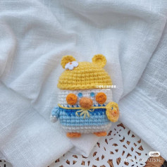 Pattern of crochet chicks wearing yellow hats.