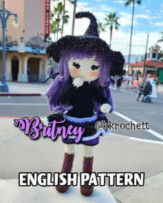 Purple hair doll crochet pattern wearing a black hat and black skirt.