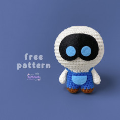 Blue-eyed robot crochet pattern, wearing blue overalls.