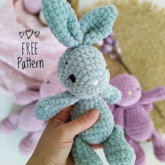Blue rabbit crochet pattern with long ears and black eyes.