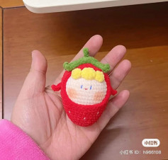 crochet pattern blonde baby wearing strawberry hat.