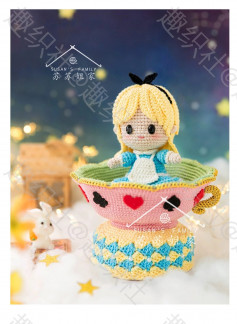 crochet pattern blonde doll sitting in pink cup.