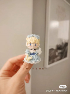 crochet pattern blonde doll wearing light blue dress.