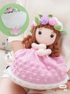 crochet pattern brown hair doll, wearing a pink dress, wearing a laurel wreath on her head.
