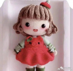 crochet pattern brown haired doll wearing red dress.