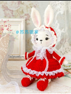 crochet pattern doll wearing rabbit ears hat wearing red dress.