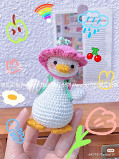 crochet pattern duck wearing a raspberry backpack.