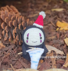 Crochet pattern for a ghost doll wearing a hat.
