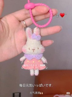 crochet pattern long-eared rabbit keychain tied with a bow.