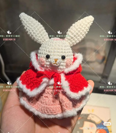 crochet pattern long-eared rabbit wearing a pink skirt over a red coat.