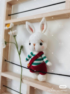 crochet pattern long-eared rabbit wearing cross pants.